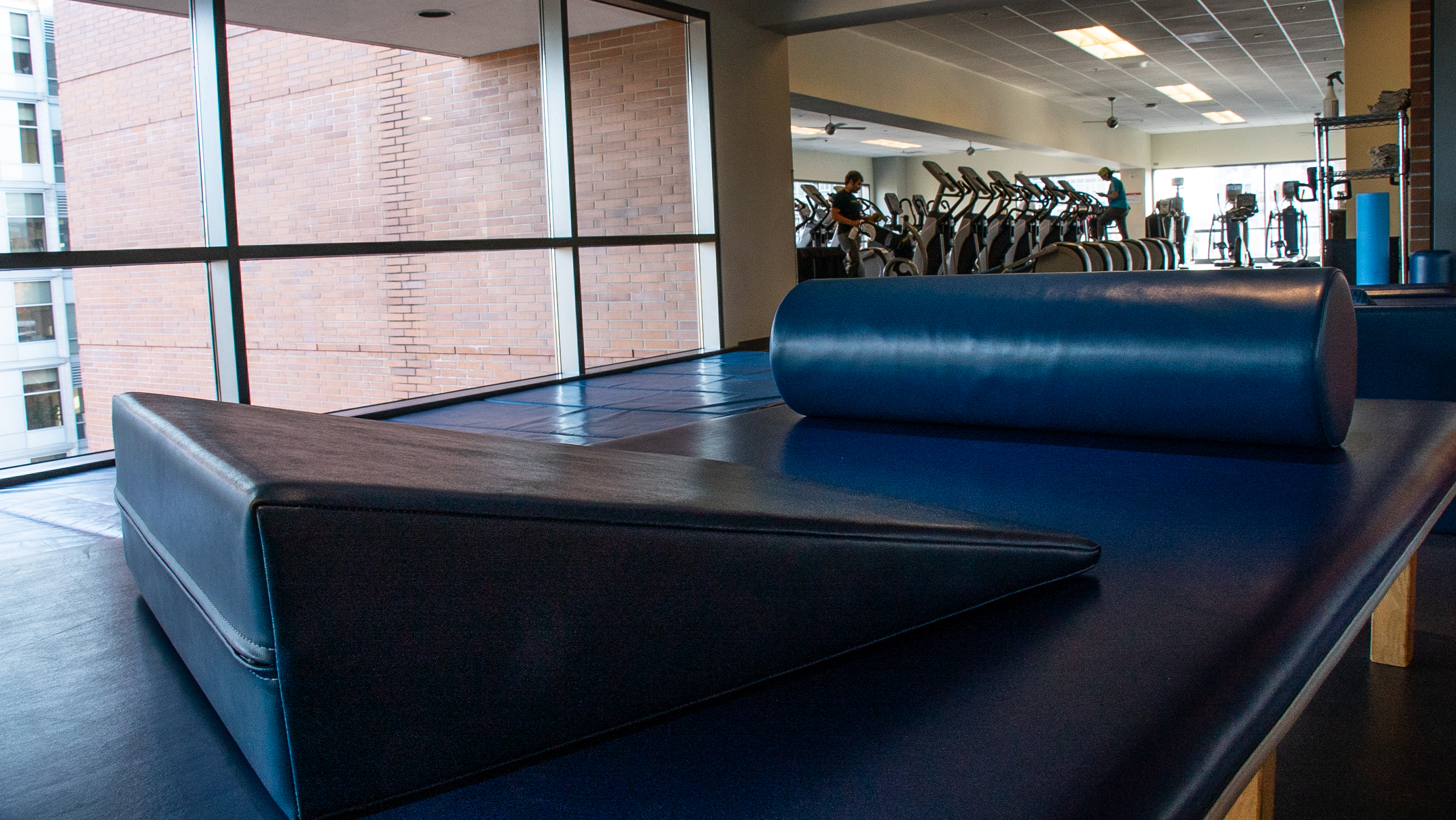 The image is of gym mats and exercise equipment in a gym. 